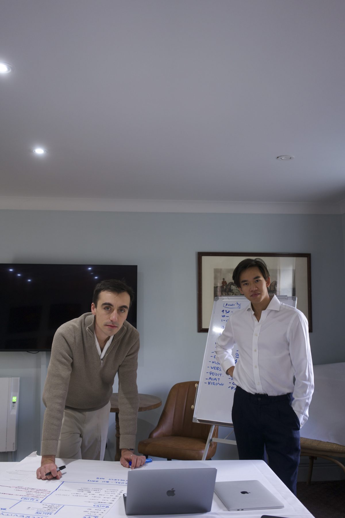 Julius Foo and Daniel Reynolds working with a client